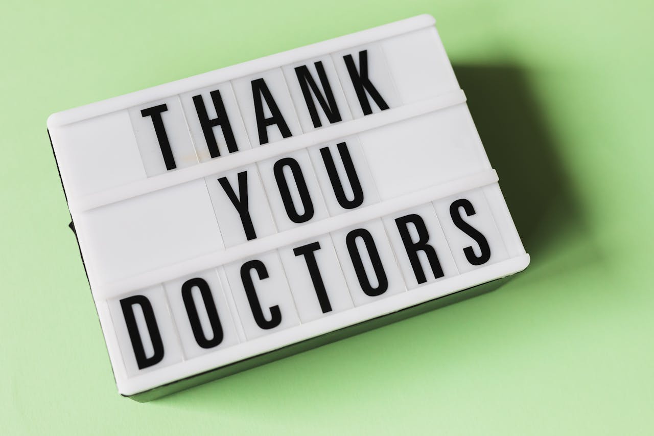 services-03 From above of vintage light box with THANK YOU DOCTORS gratitude message placed on green surface